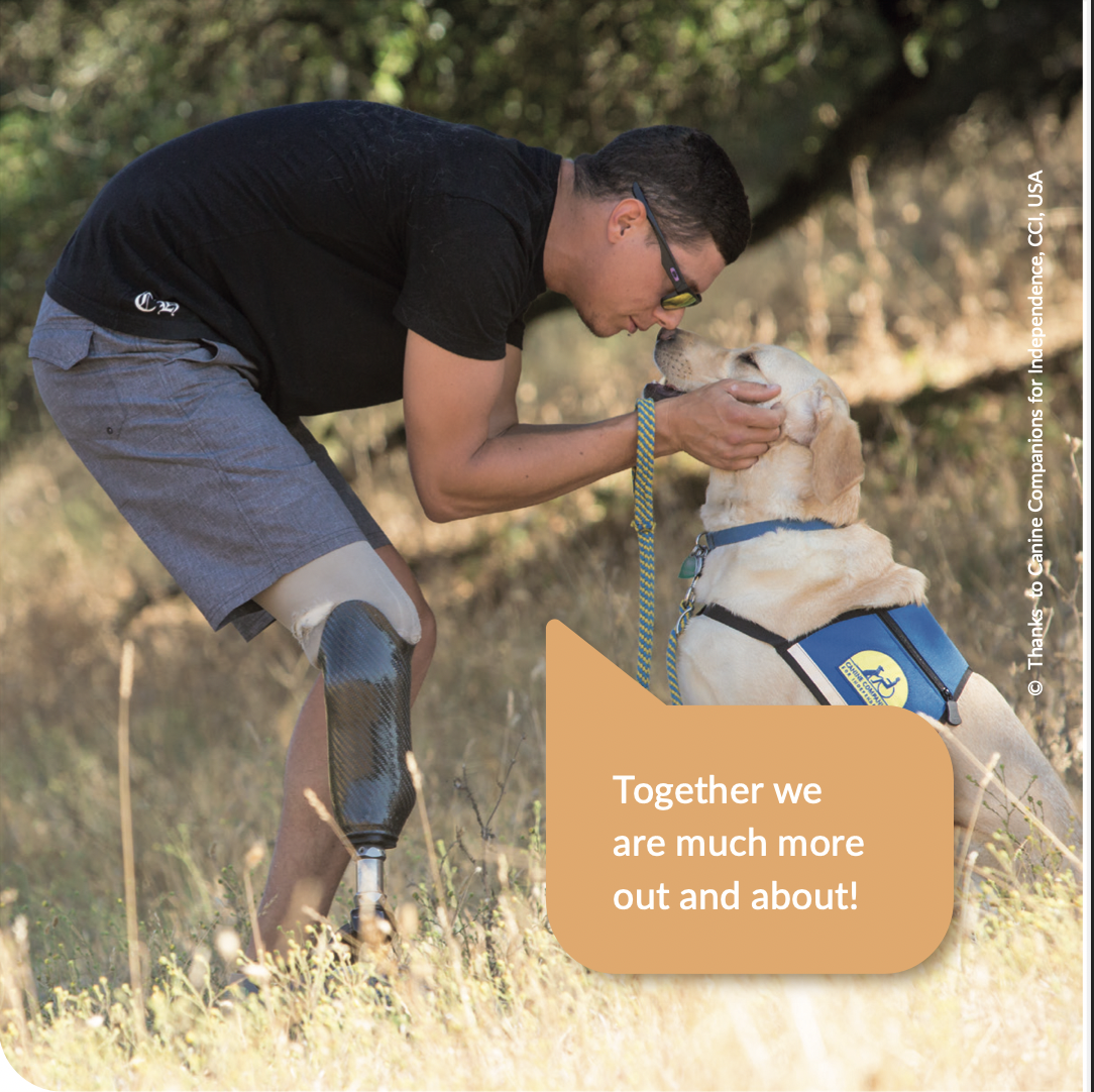 A man with a prosthetic leg leans over his assistance dog, a light-colored Labrador, who looks up happily. In addition, the speech bubble "Together we are much more human again!"